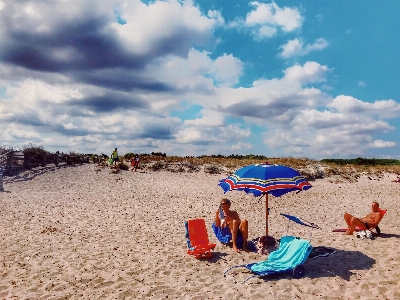 People on beach sand umbrella Photo