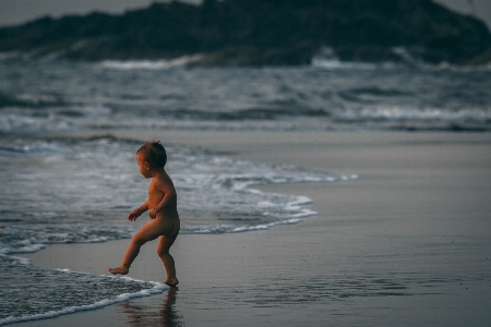 People on beach wave water Photo