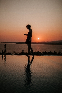 People in nature water sky sunset Photo