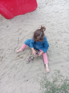 Girl sand play pink Photo