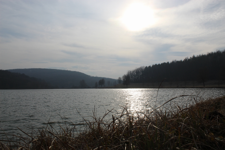 Mountains fishing body of water sky