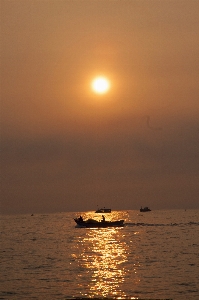 Beach sunrise ship sky Photo