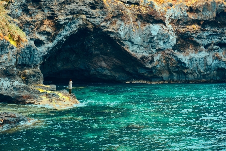 Sea cave woman body of water Photo