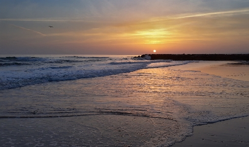 Sunset beach sky body of water Photo