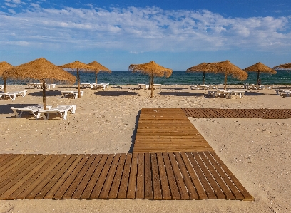 Beach sand sky sunlounger Photo