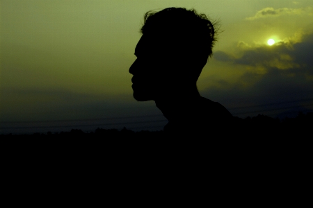 Young boy sunsets gold sky Photo