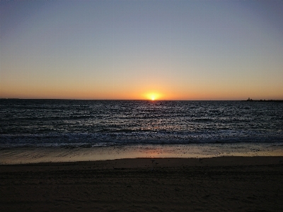 Sunset waves shoreline sky Photo