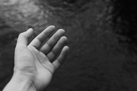 Hand stretching out hands to Photo