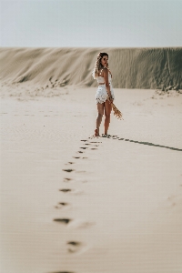 Girl beautiful sand white Photo