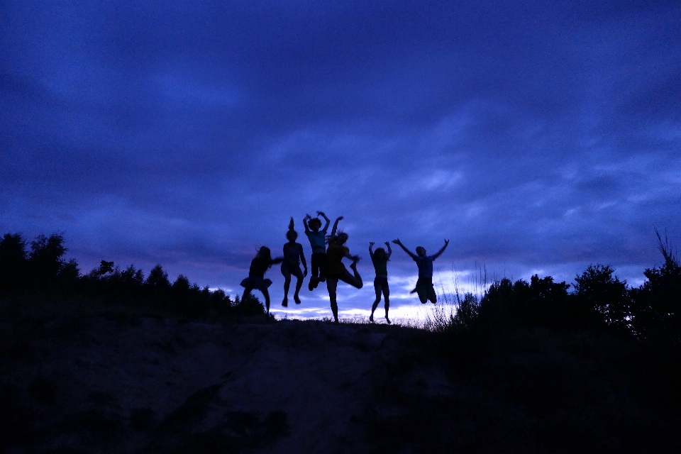 Friends silhouette blue jump