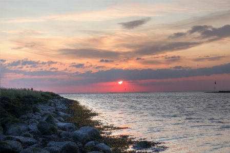 Sunrise sky body of water horizon Photo