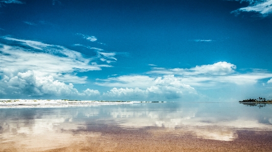 Blue sky beach mirror Photo