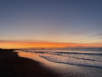 Sun sand sky body of water Photo