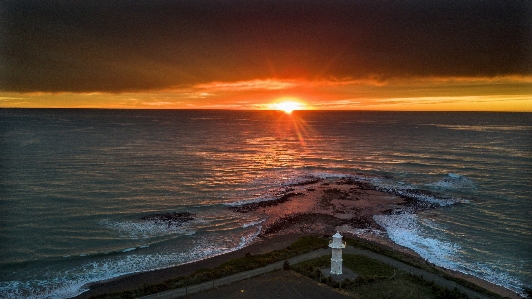 Light house sunrise sea scape horizon Photo