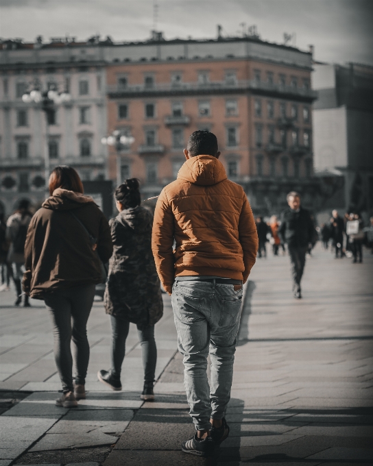 People photograph pedestrian standing