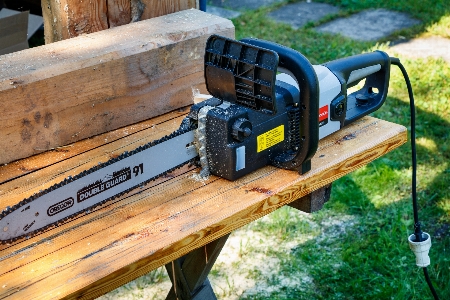 Electric saw logs work wood Photo