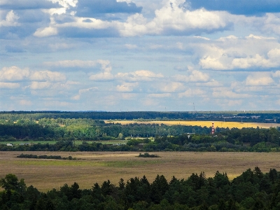 Fields clouds horizon trees Photo