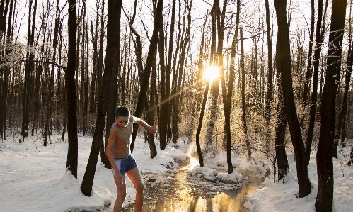 Boy winter snow creek Photo