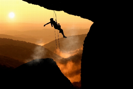 Climber courage cliff sunlight Photo