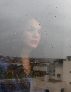 Snow woman rain window Photo